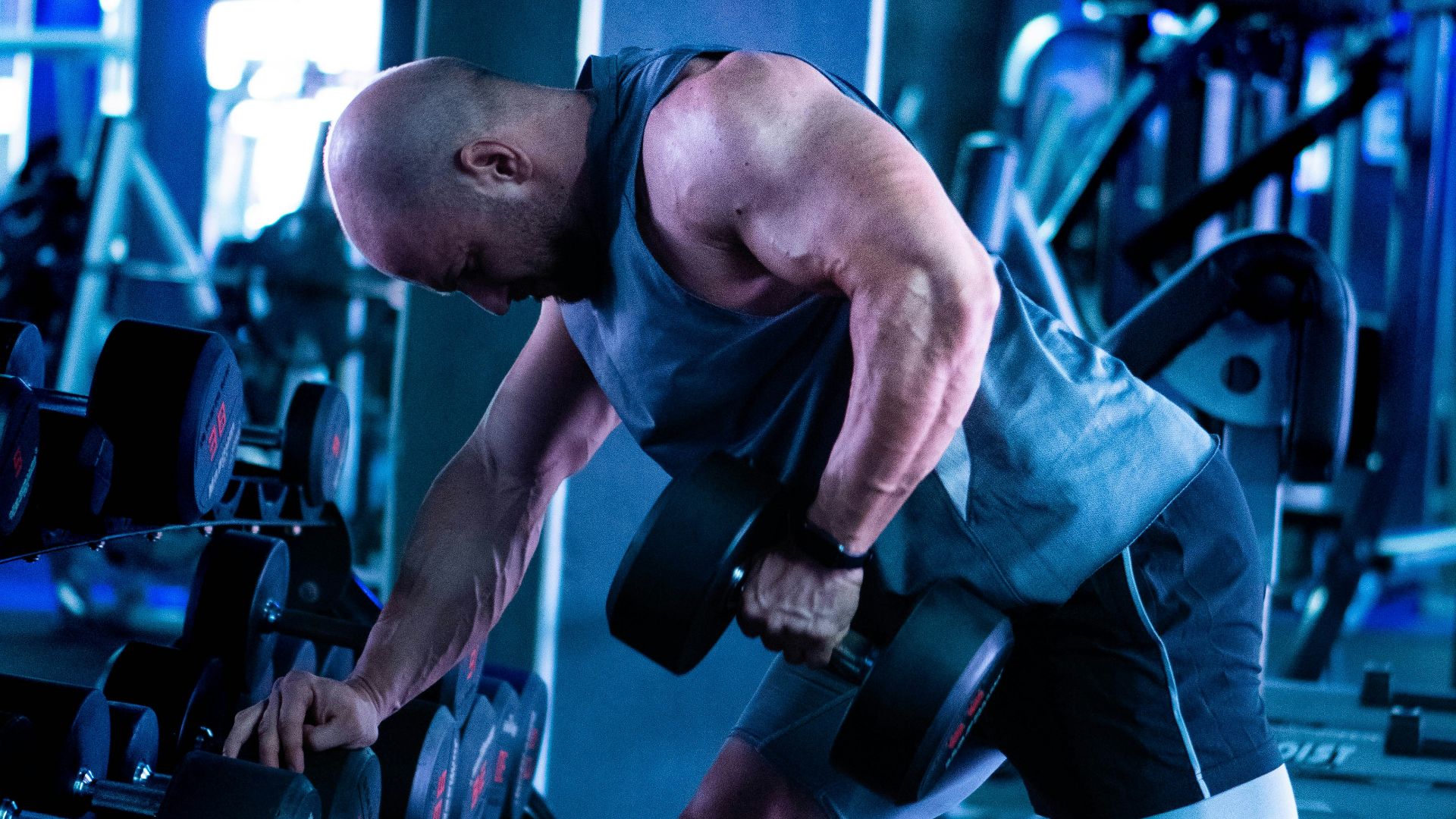 a man working out with a barbell in a gym
