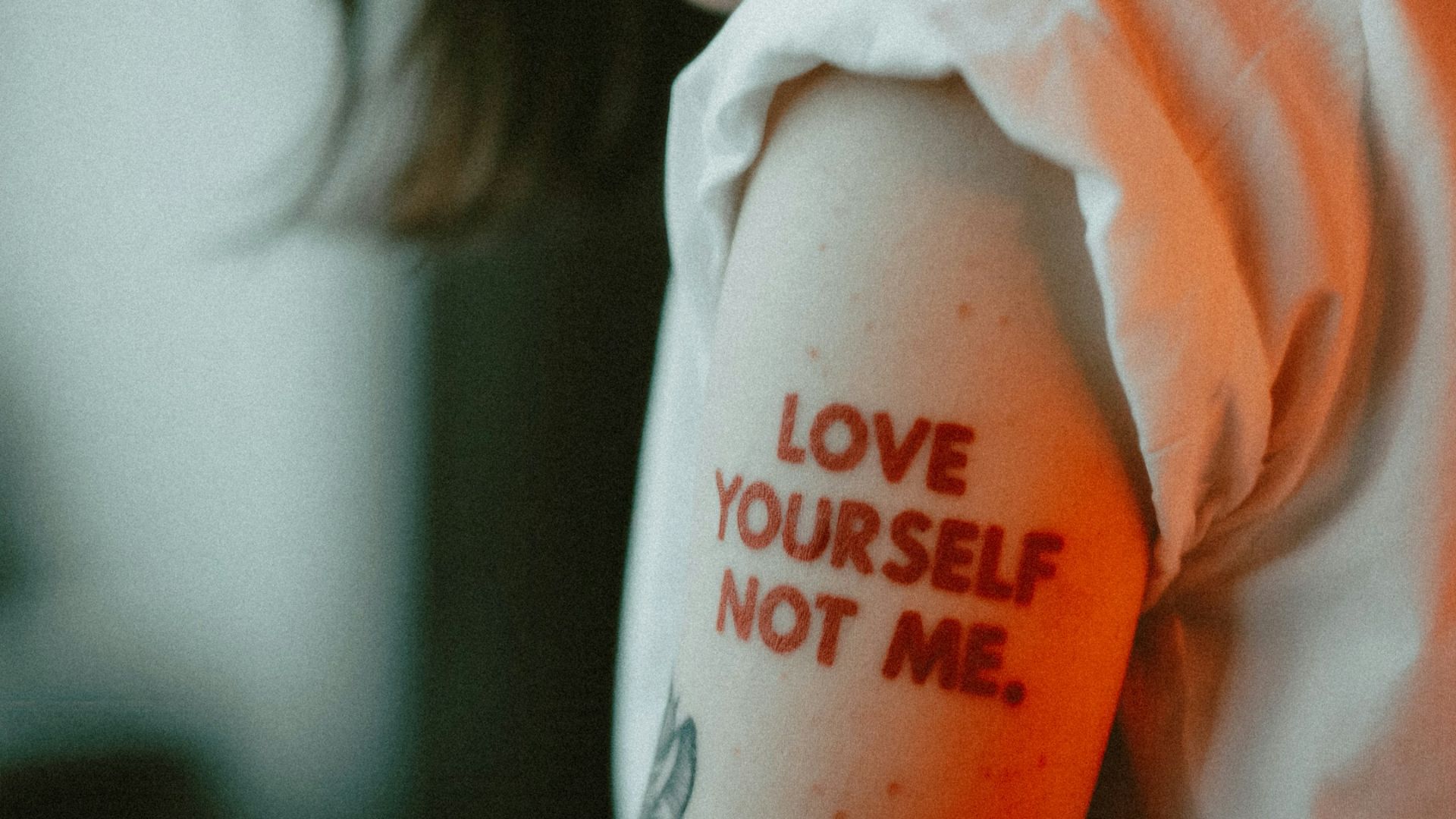 Woman displays a tattoo that reads
