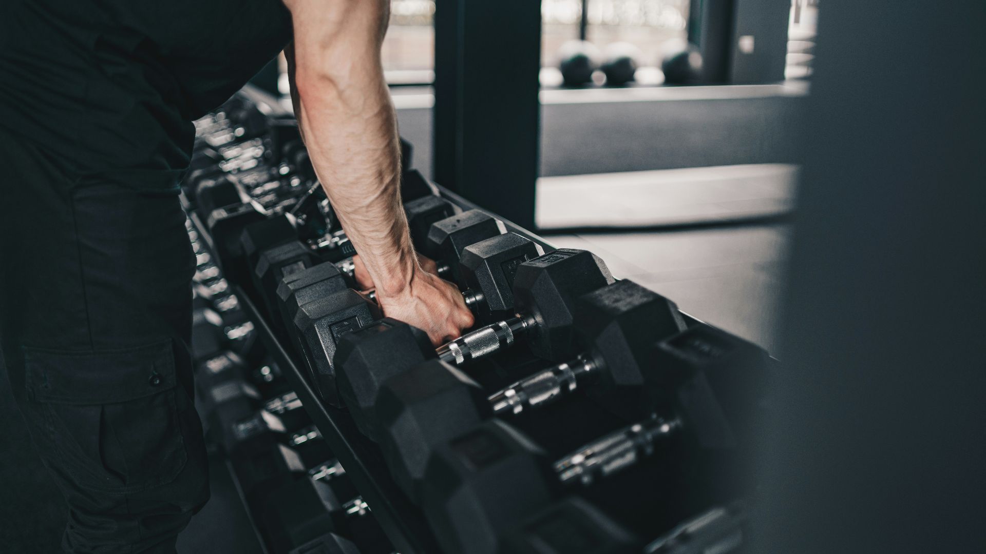 A man holding a gym equipment in a gym