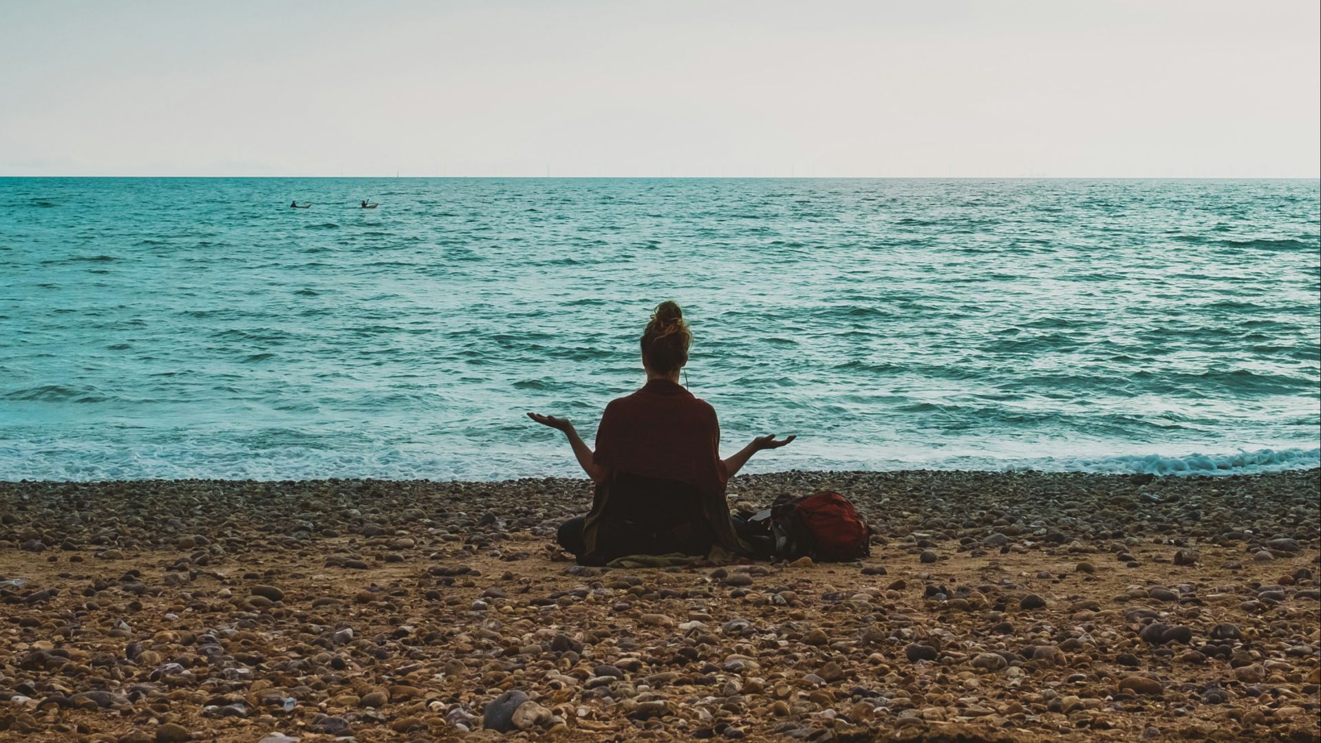 person doing yoga on seashore during daytime