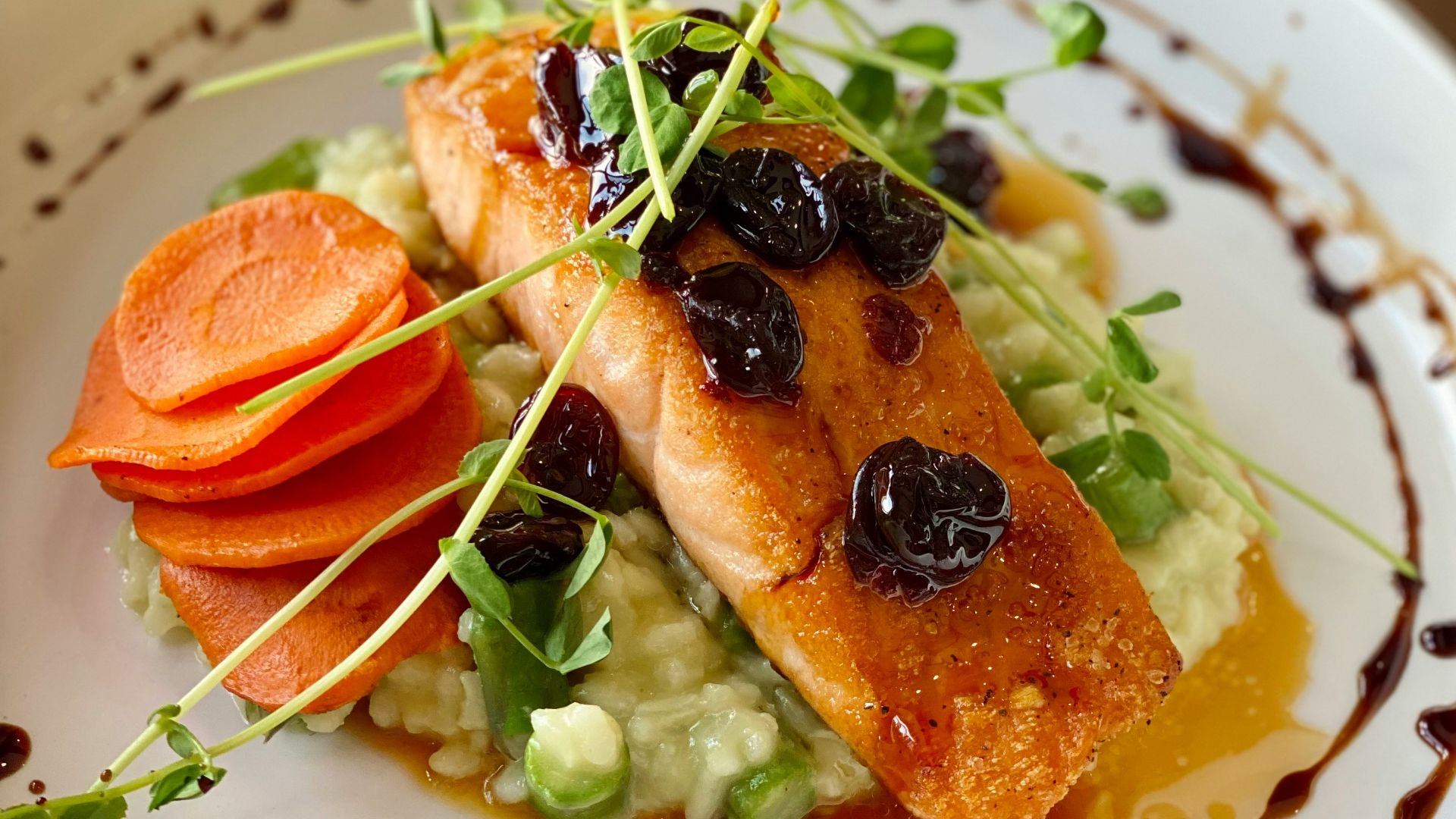 a white plate topped with fish and veggies