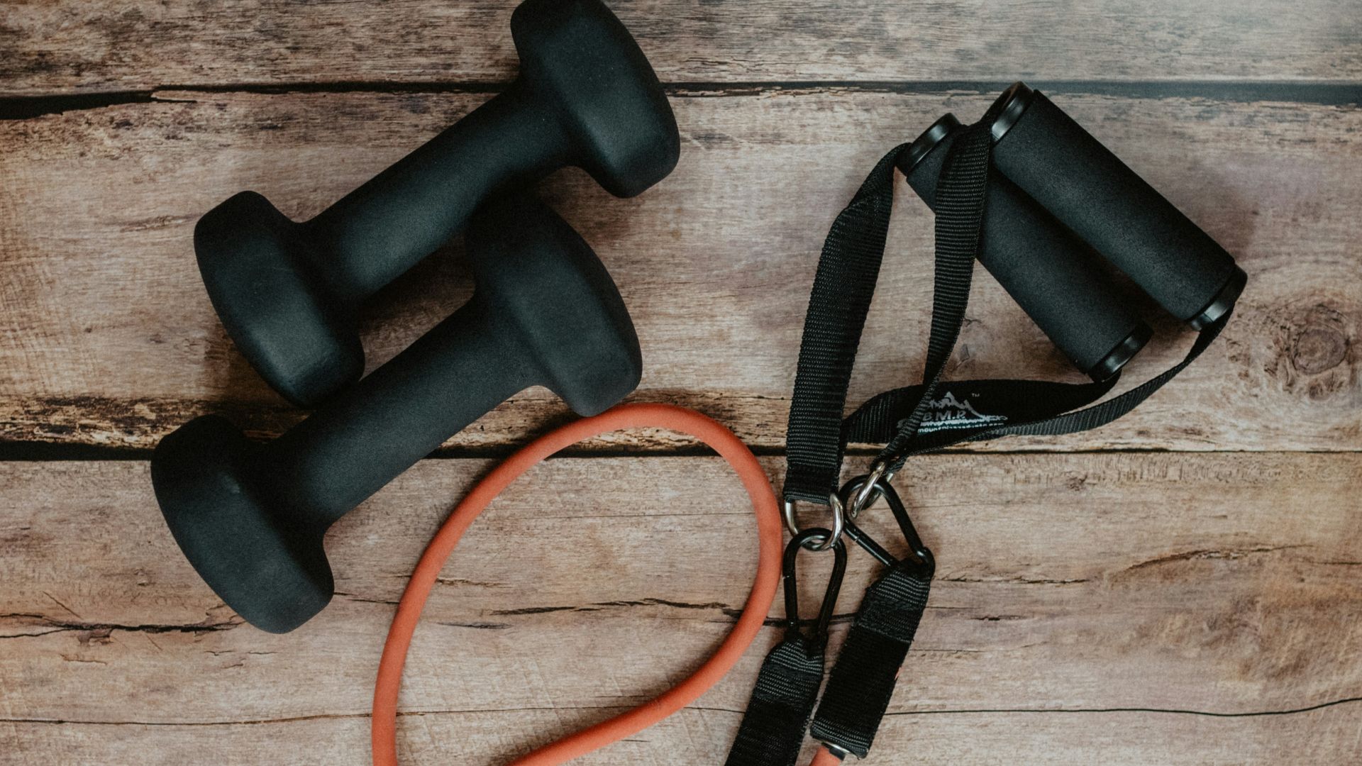 orange and black usb cable on brown wooden surface