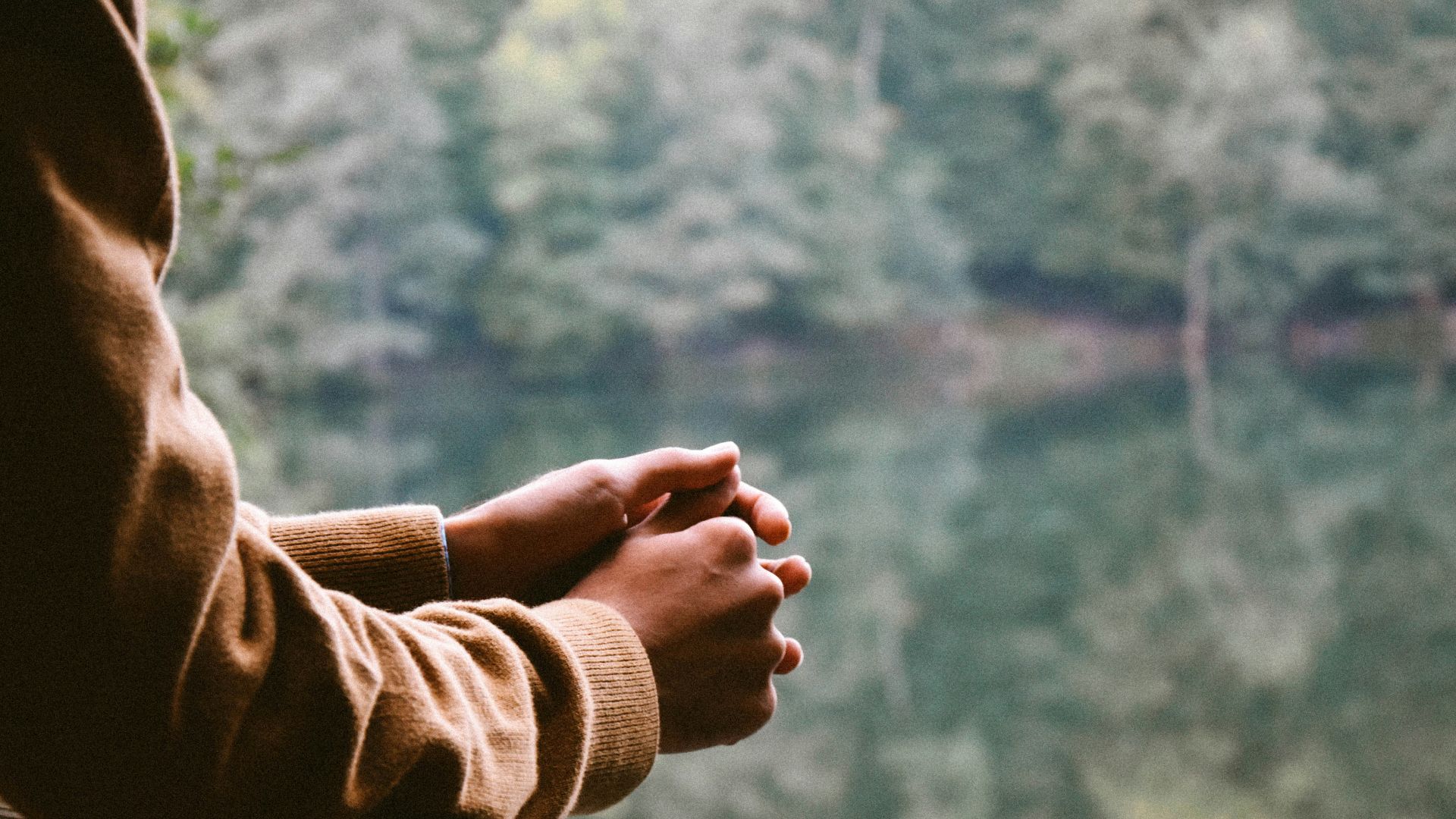 tilt-shift photography of person in brown jacket