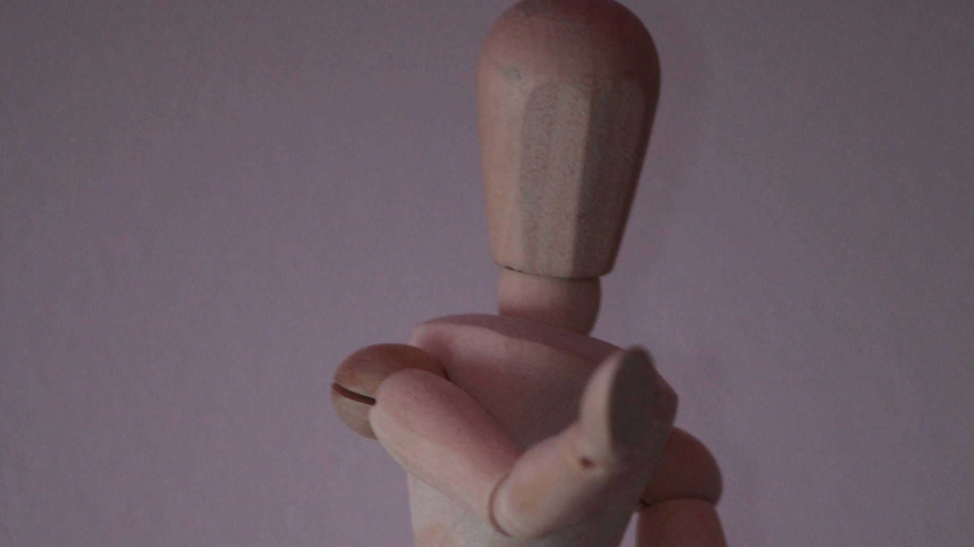 brown wooden human figure on white surface