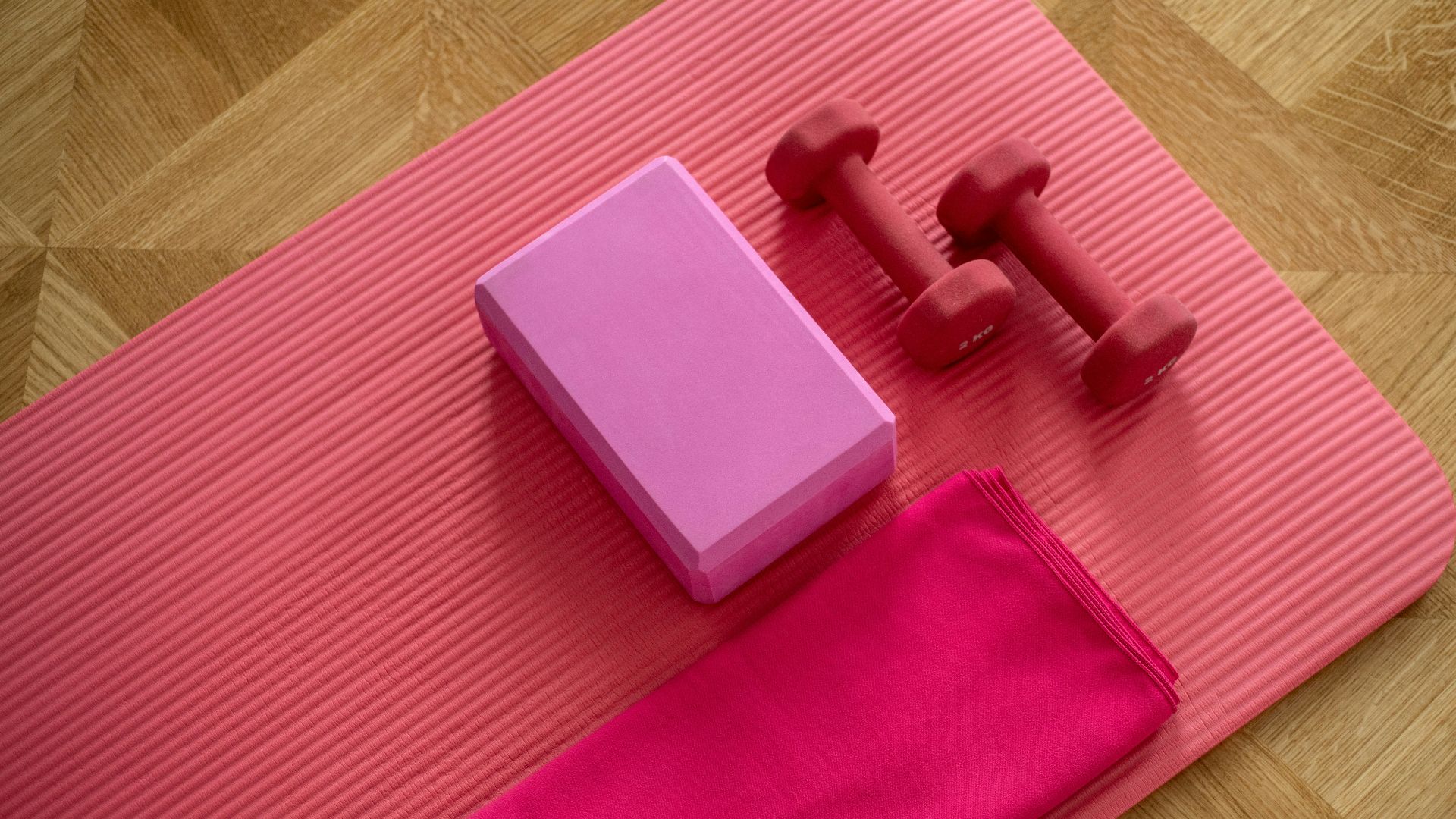 pink dumbbell on pink textile
