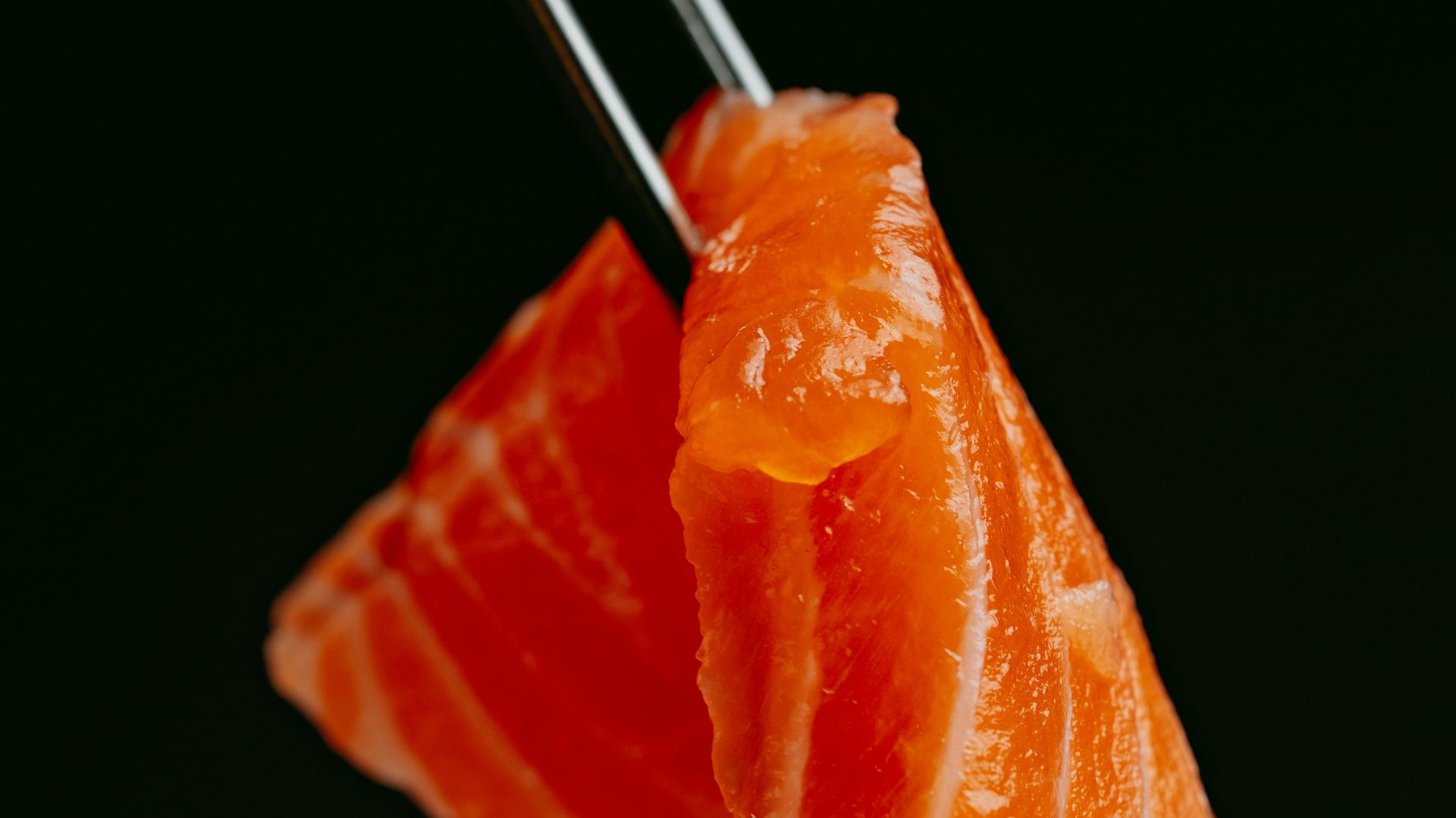 a piece of sushi with chopsticks sticking out of it