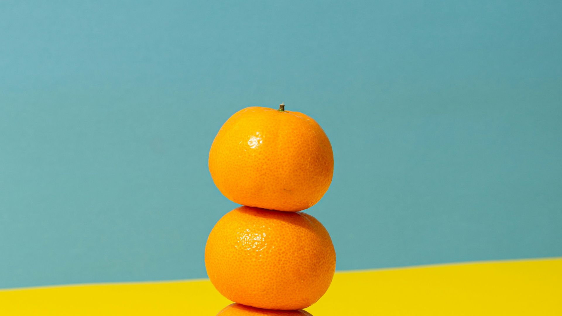 orange fruit on yellow surface