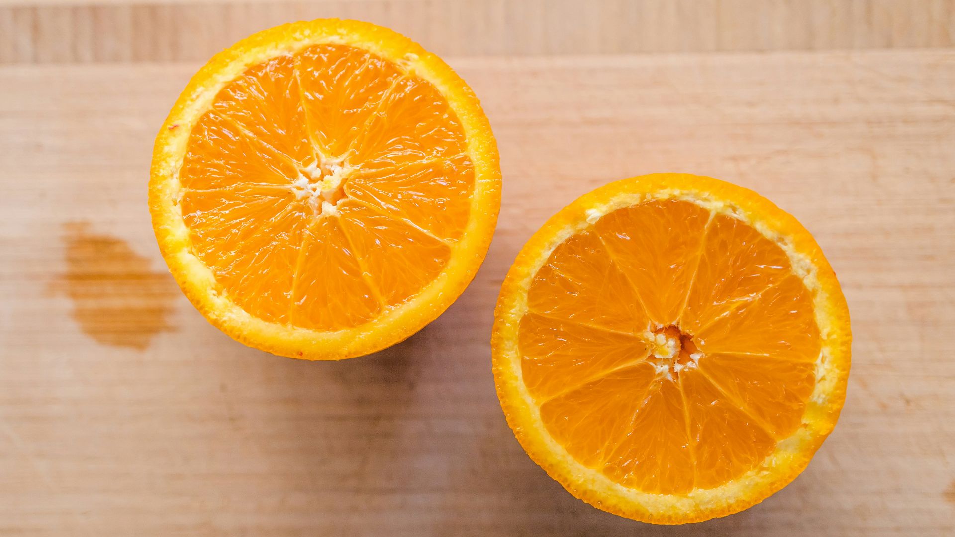 sliced orange fruit on brown wooden table