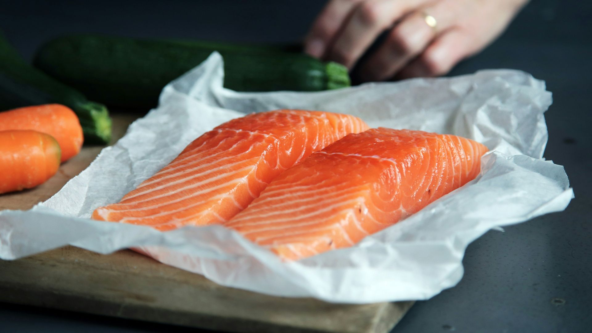 raw fish meat on brown chopping board