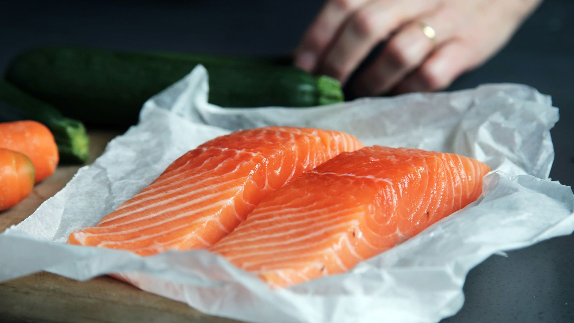 raw fish meat on brown chopping board