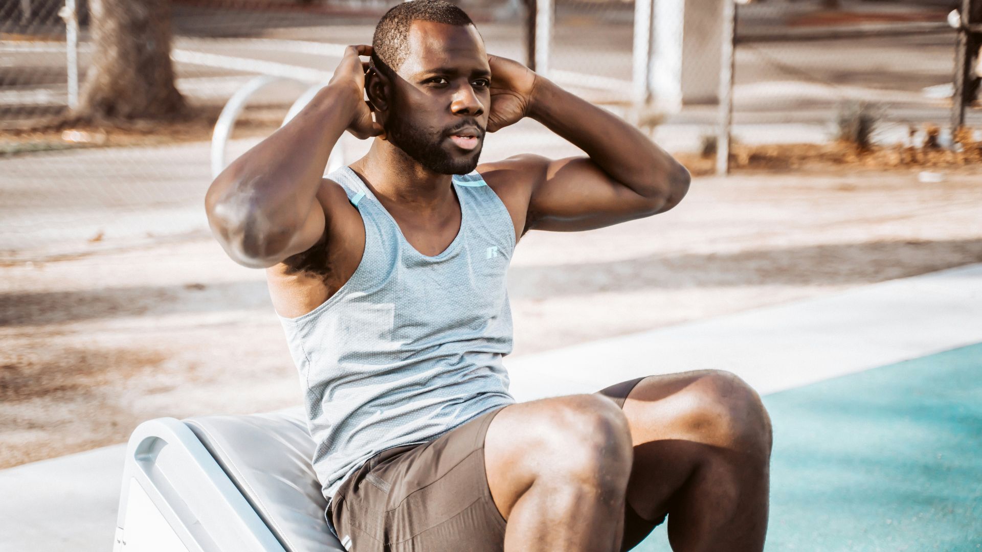 woman in white tank top and gray shorts sitting on white car