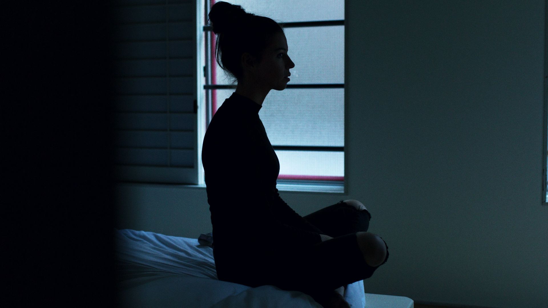 woman sitting on bed