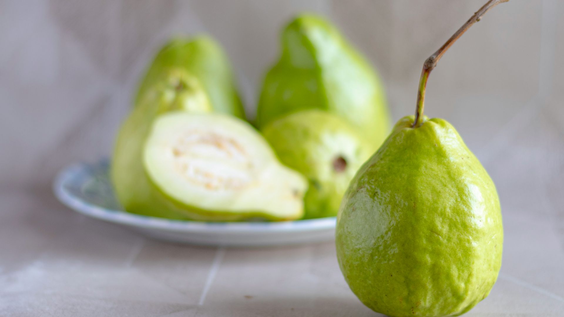 green fruit on white ceramic plate