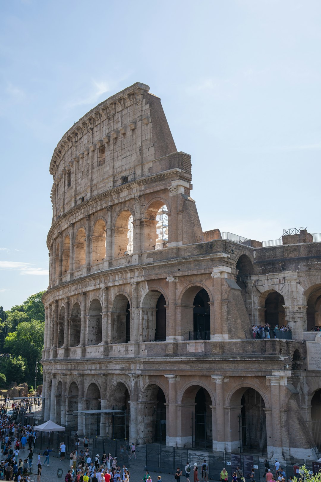 A crowd of people standing around an old building