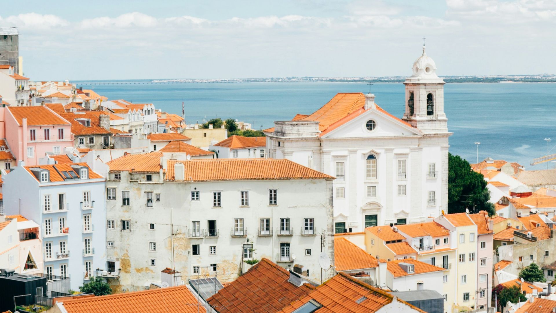 landscape photography of orange roof houses near body of water
