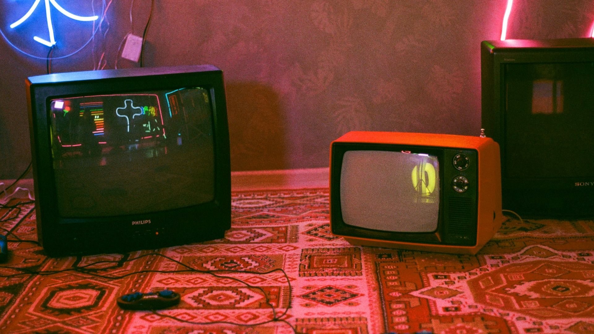 black crt tv on red and white floral textile