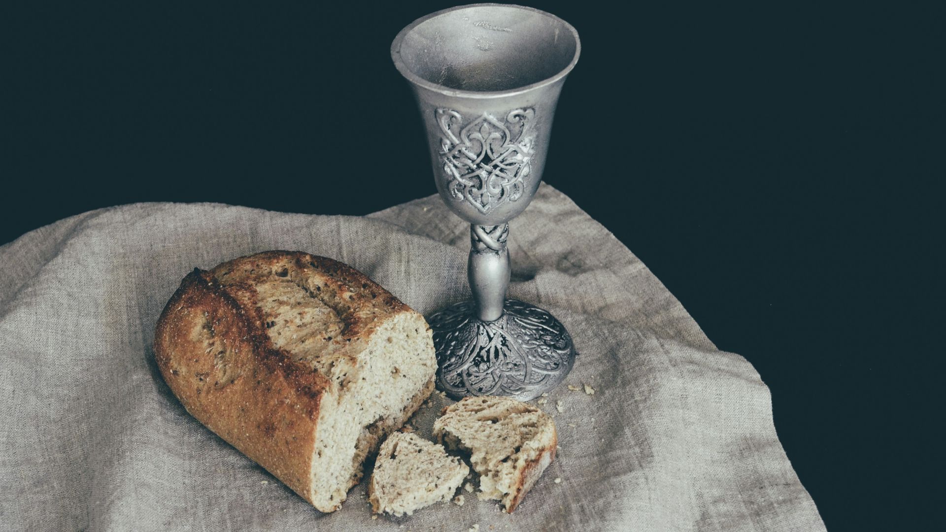 sliced of bread beside goblet
