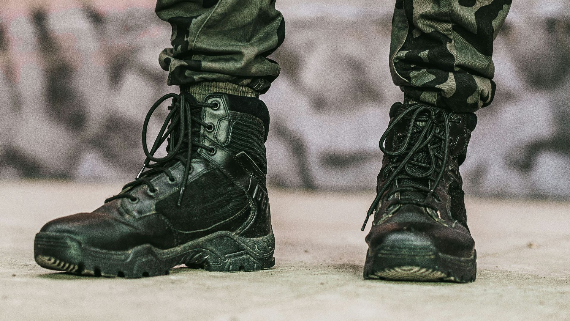 person in black leather boots