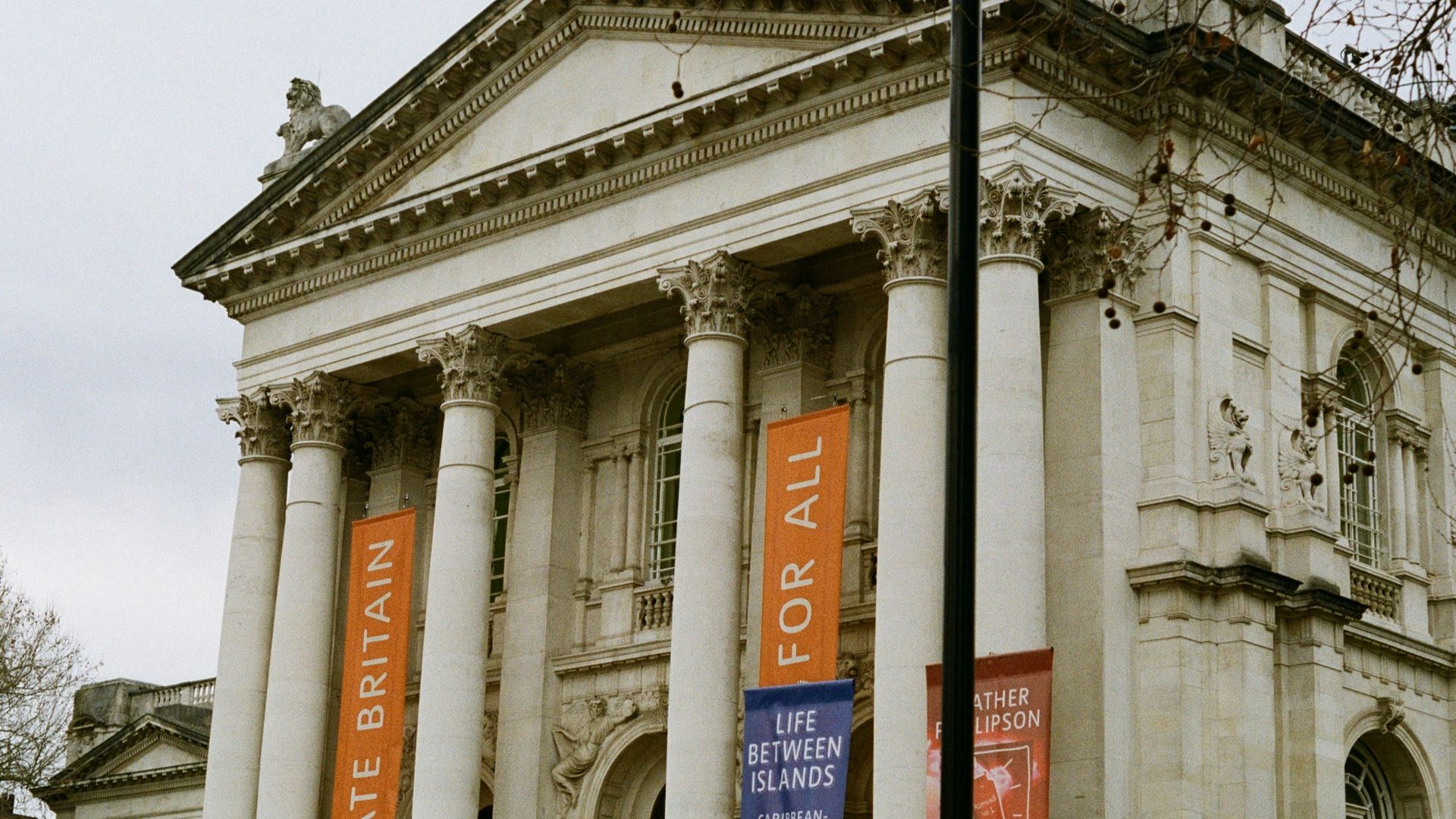 a large building with columns and banners on it