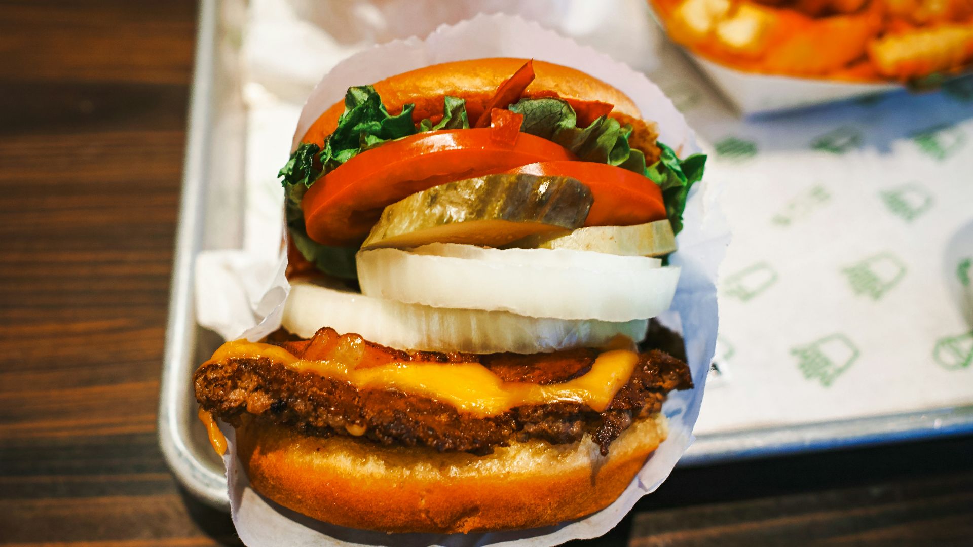 a tray with a sandwich and a bowl of fries