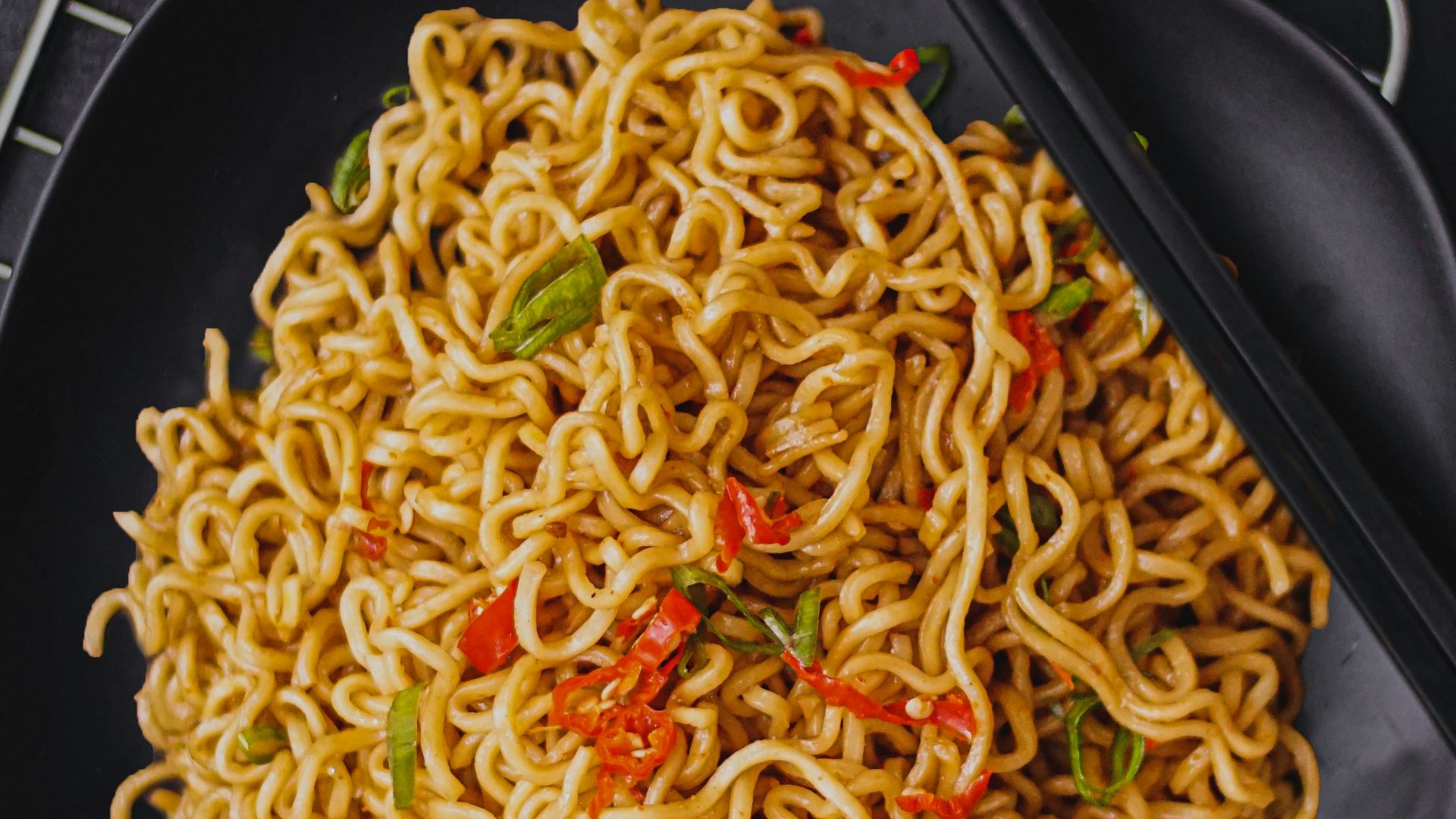 pasta dish on black plate