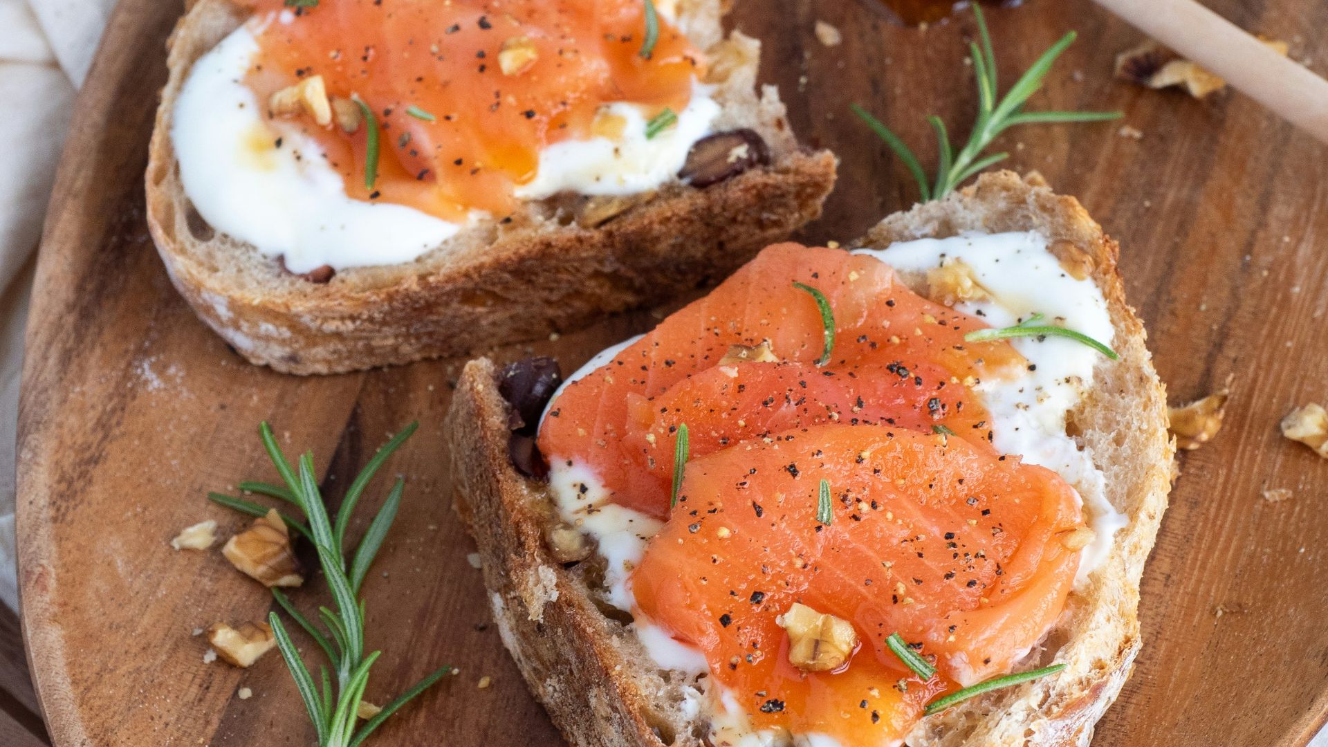 sliced bread with sliced tomato on brown wooden chopping board