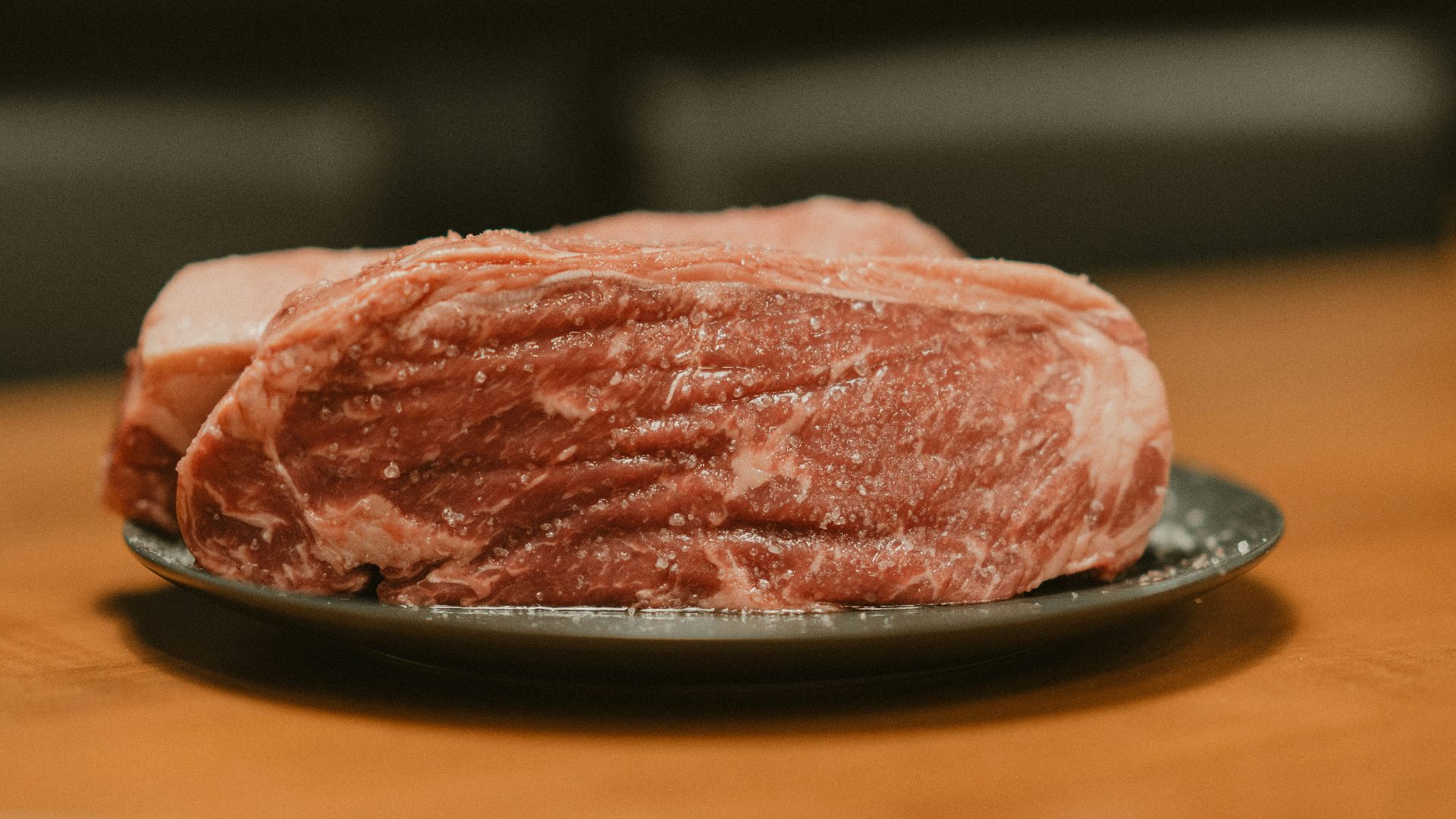 A piece of meat on a plate on a table