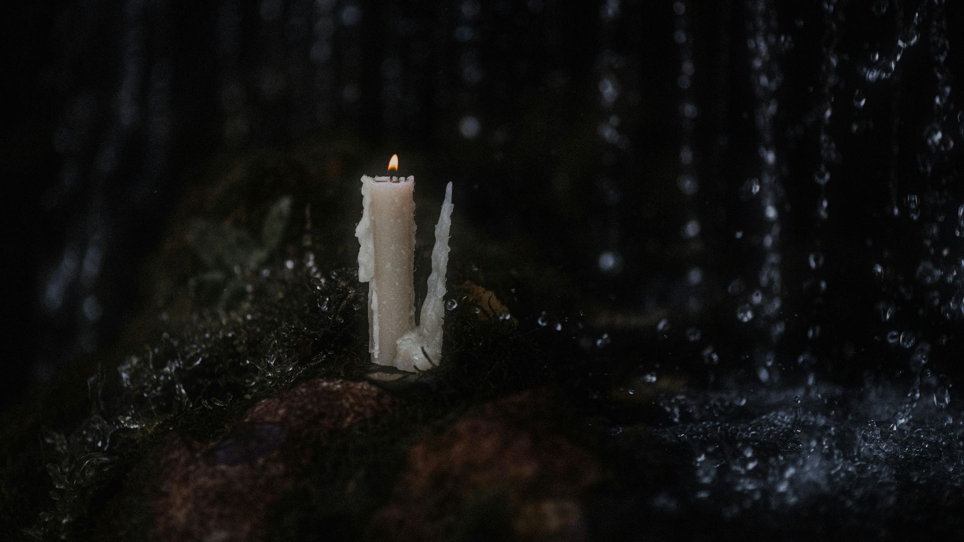 a candle on a rock