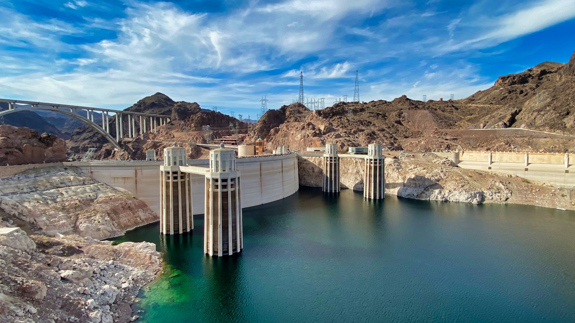 gray concrete dam under blue sky during daytime