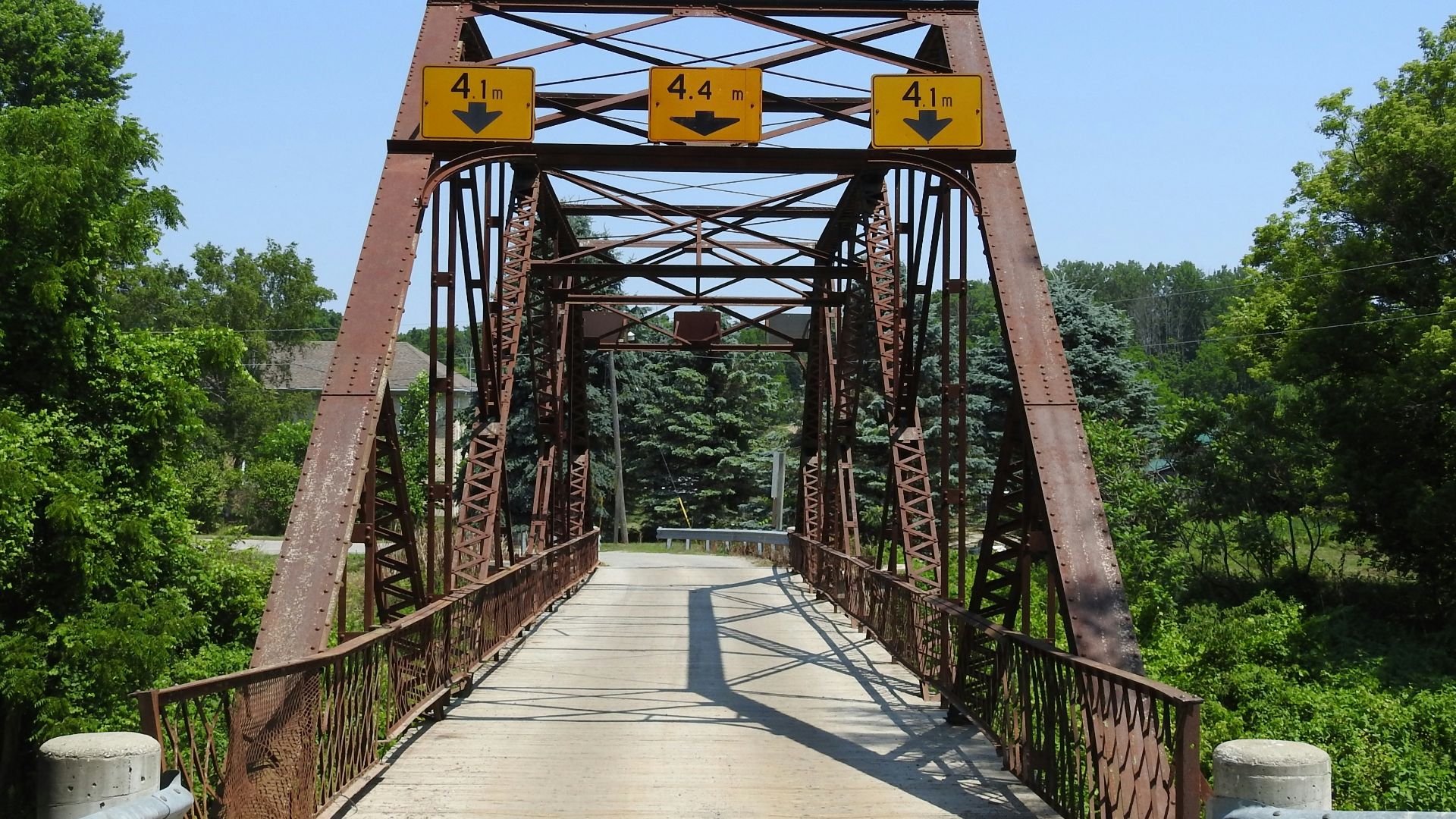brown wooden bridge under blue sky during daytime