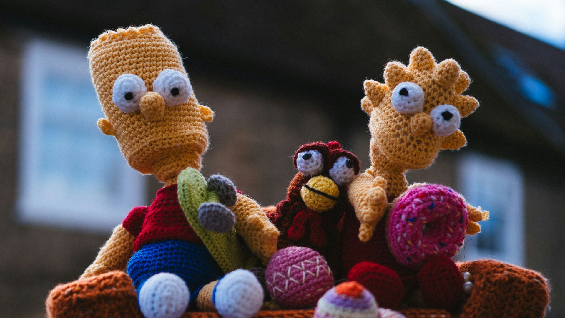 a couple of stuffed animals sitting on top of a fire hydrant