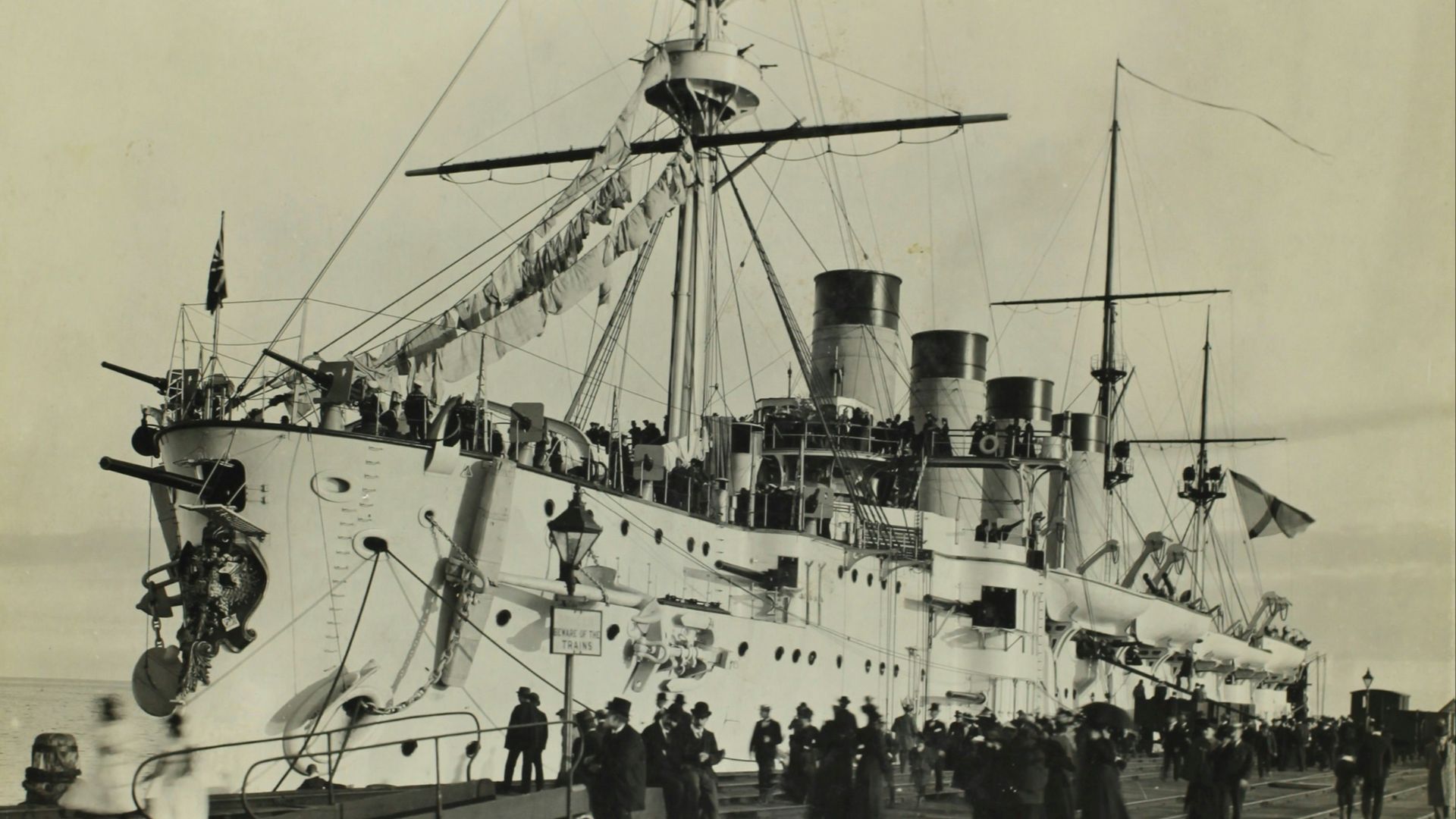 grayscale photo of ship on pier
