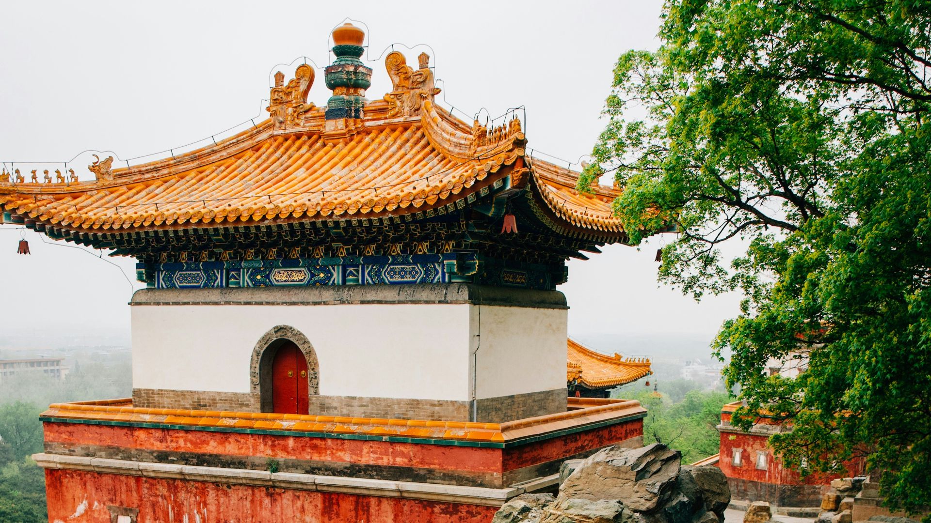 a red and white building surrounded by rocks