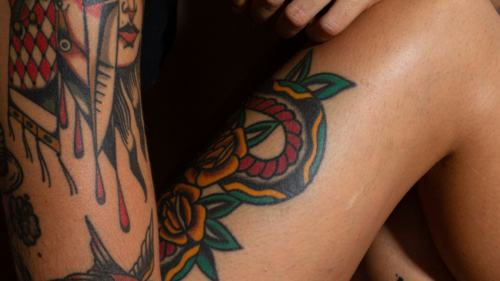 person with black and red tattoo on right leg