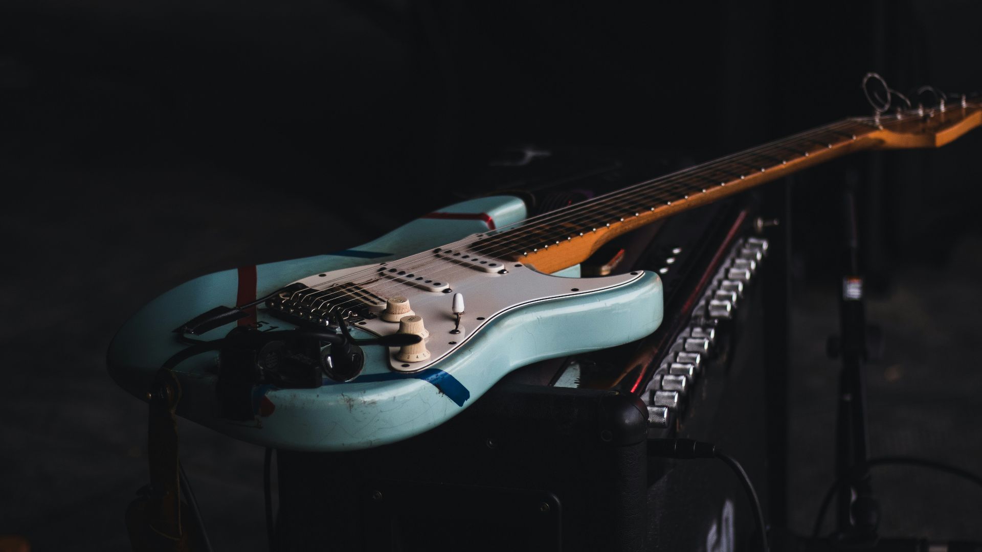 teal and brown electric guitar