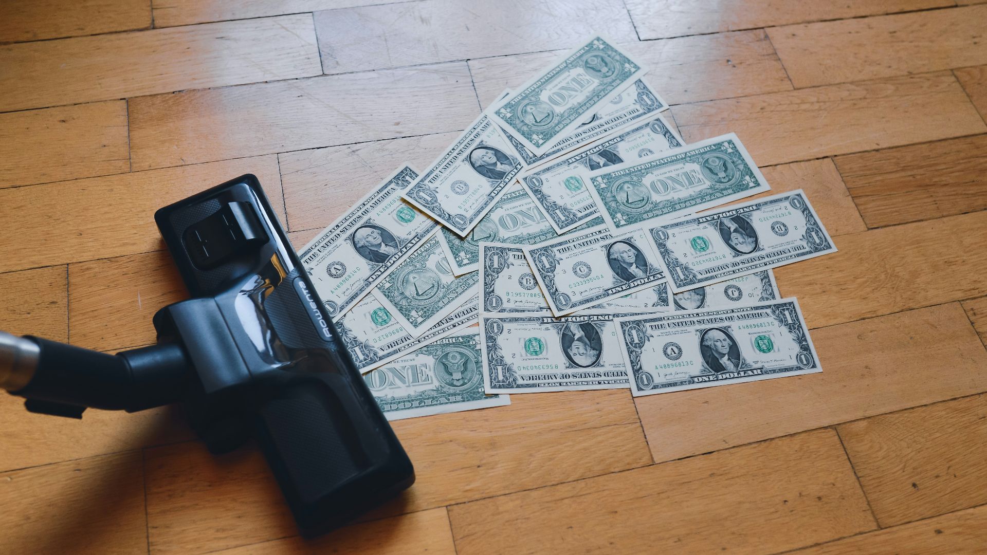 a pile of money sitting on top of a wooden floor
