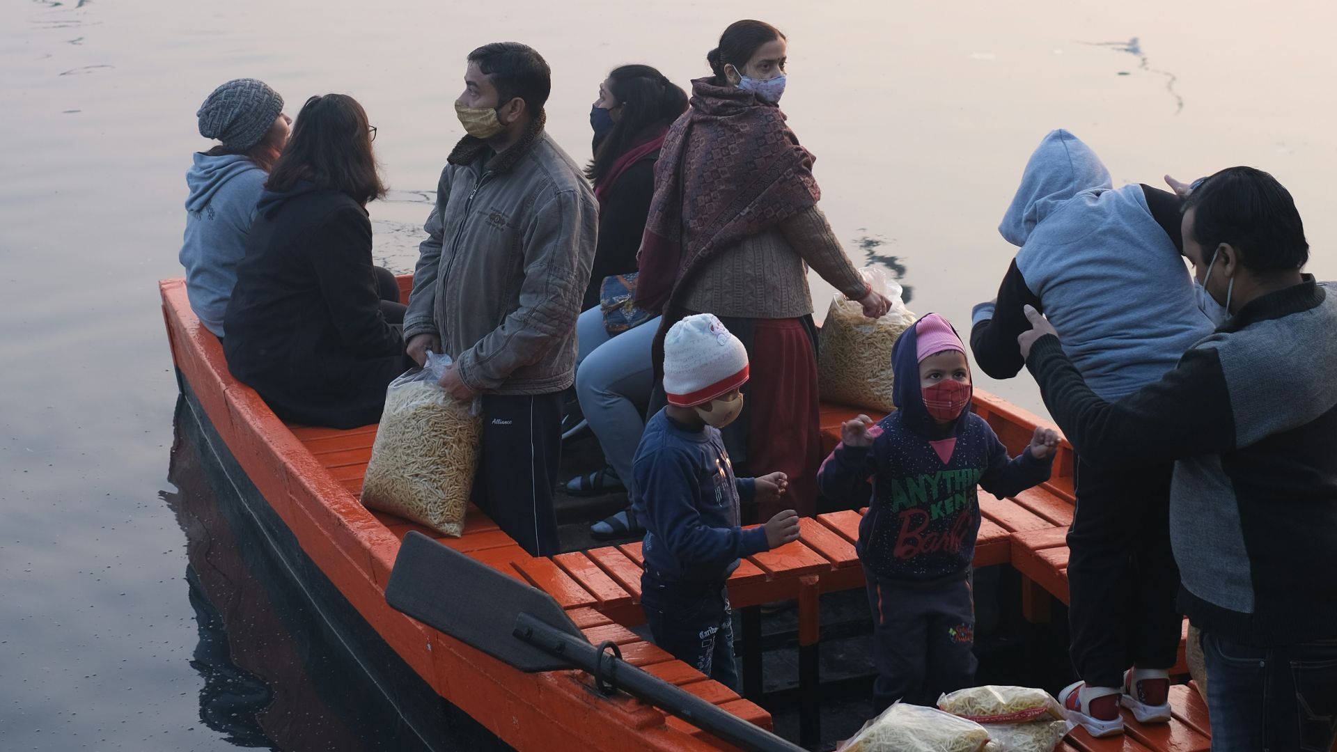 a group of people in a boat on the water