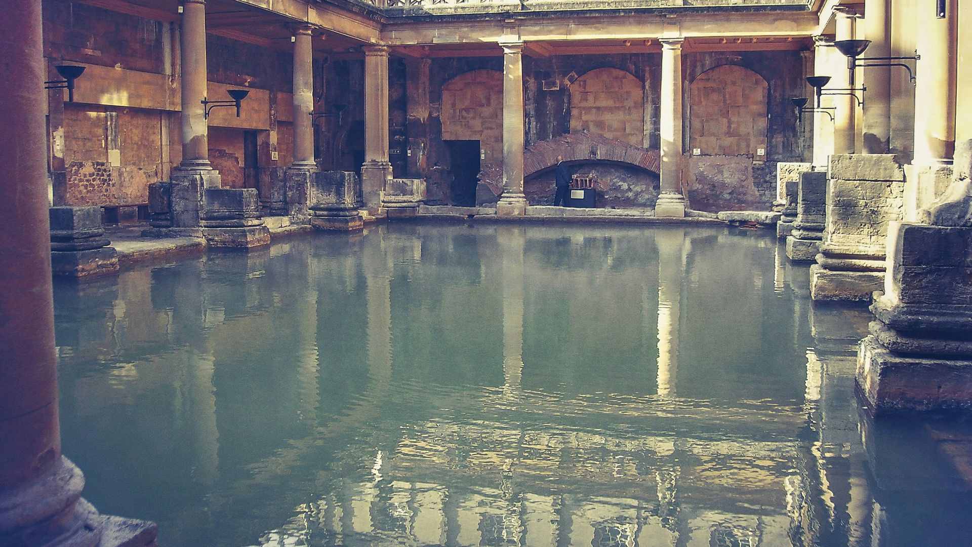 brown pillars beside body of water