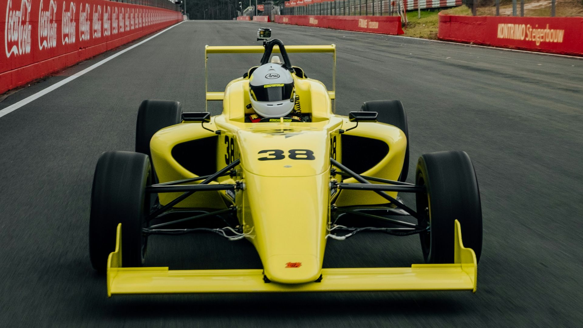 yellow and black f 1 car on road during daytime
