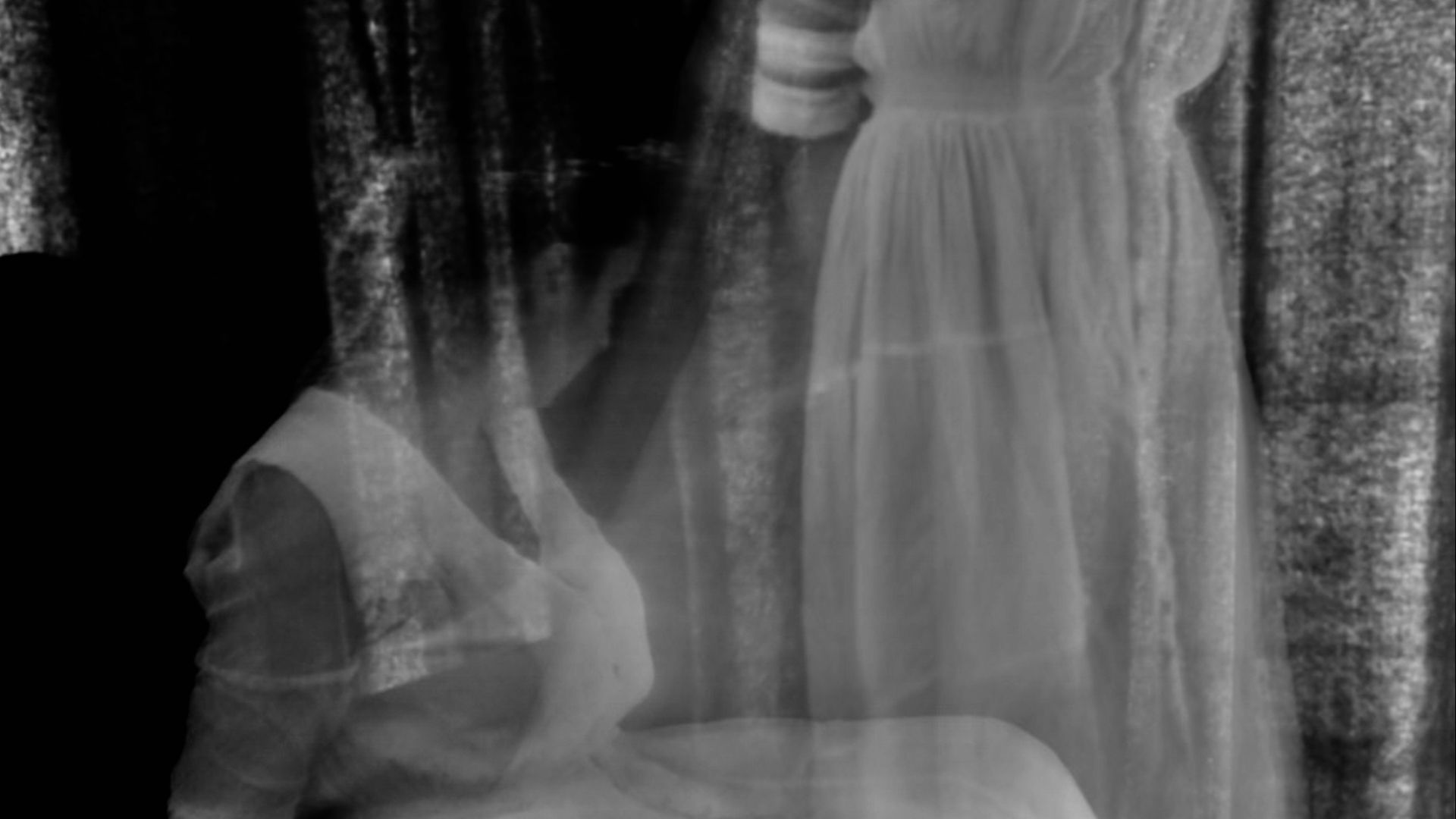 a black and white photo of a woman in a white dress