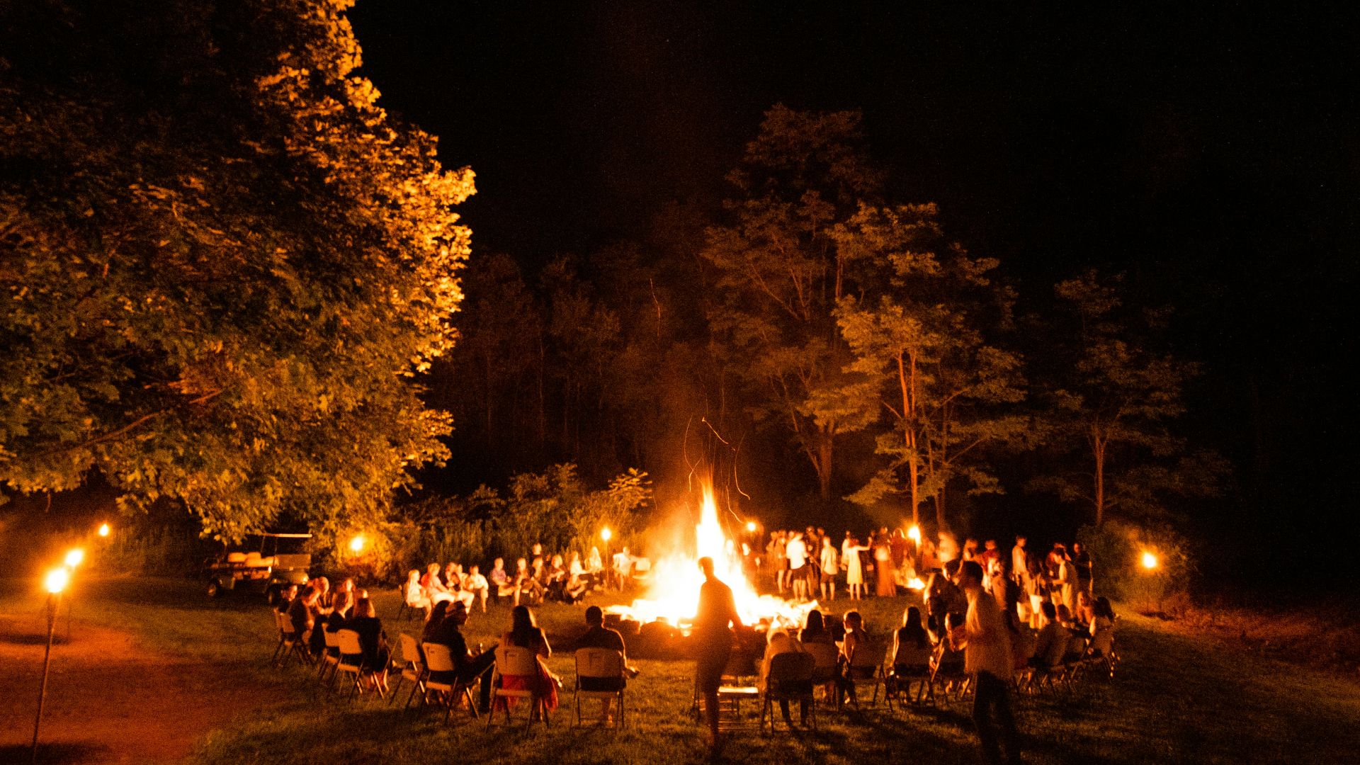 people sitting around bonfire