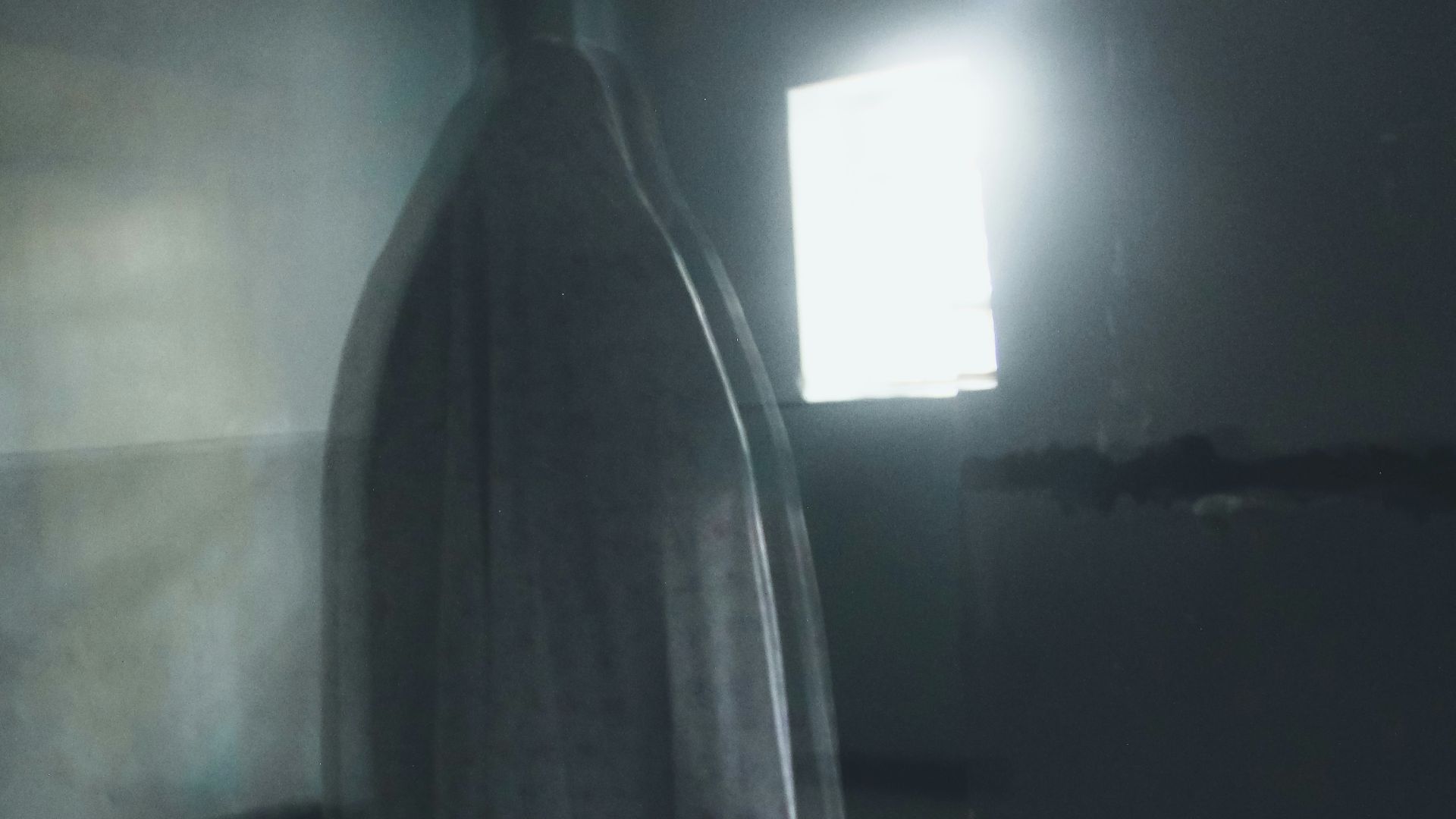 a ghostly figure standing in a dark room