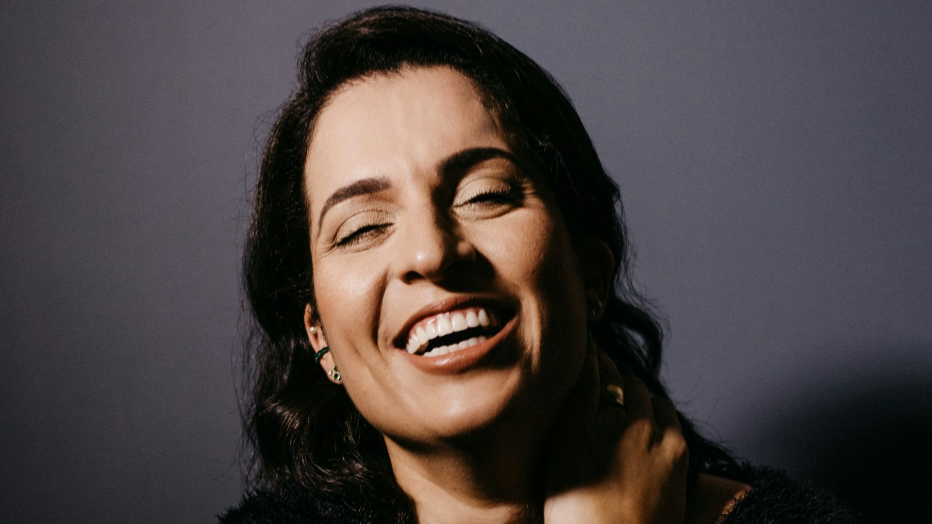 smiling woman in black fur coat