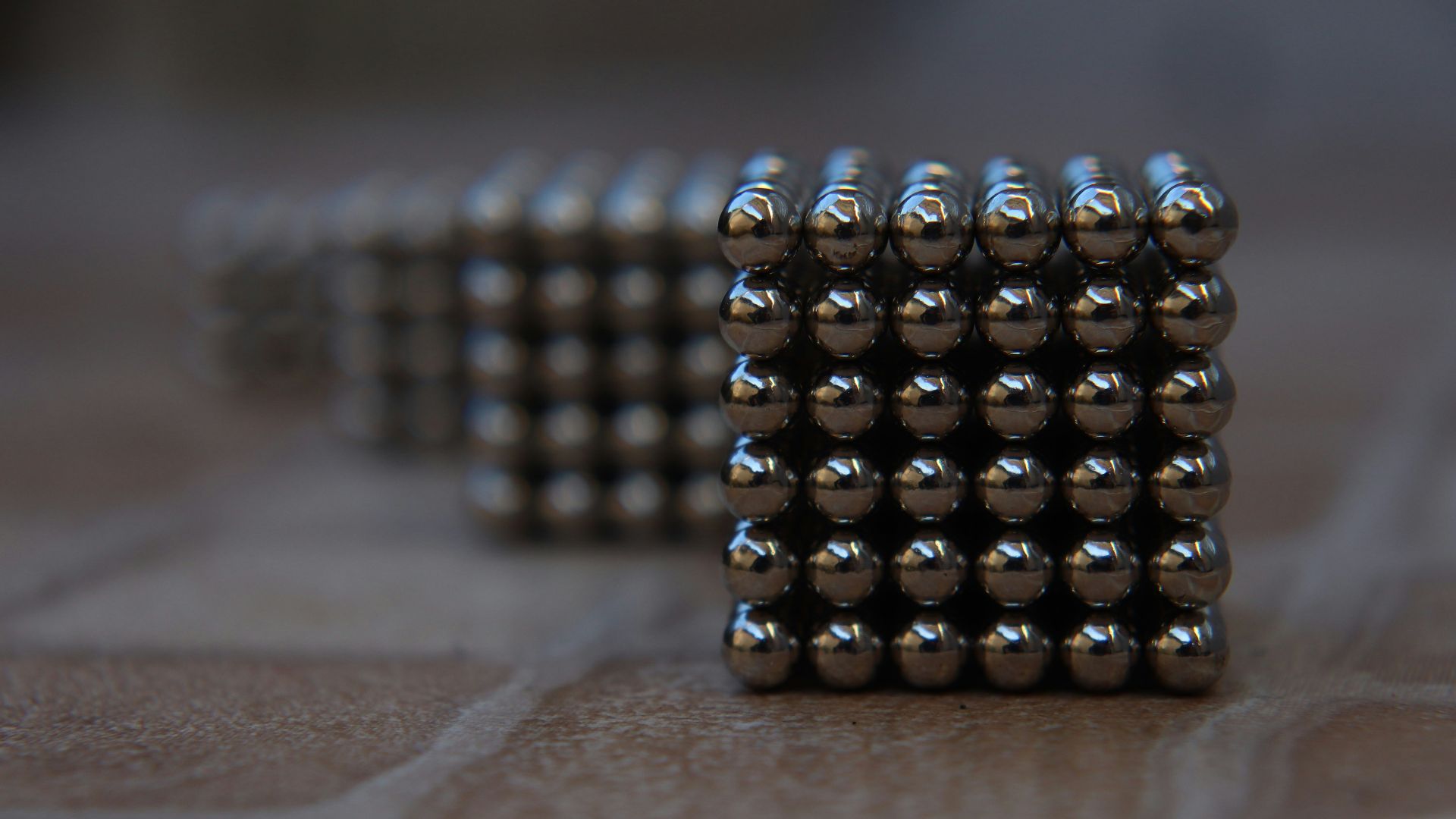 silver and black beads on brown wooden table