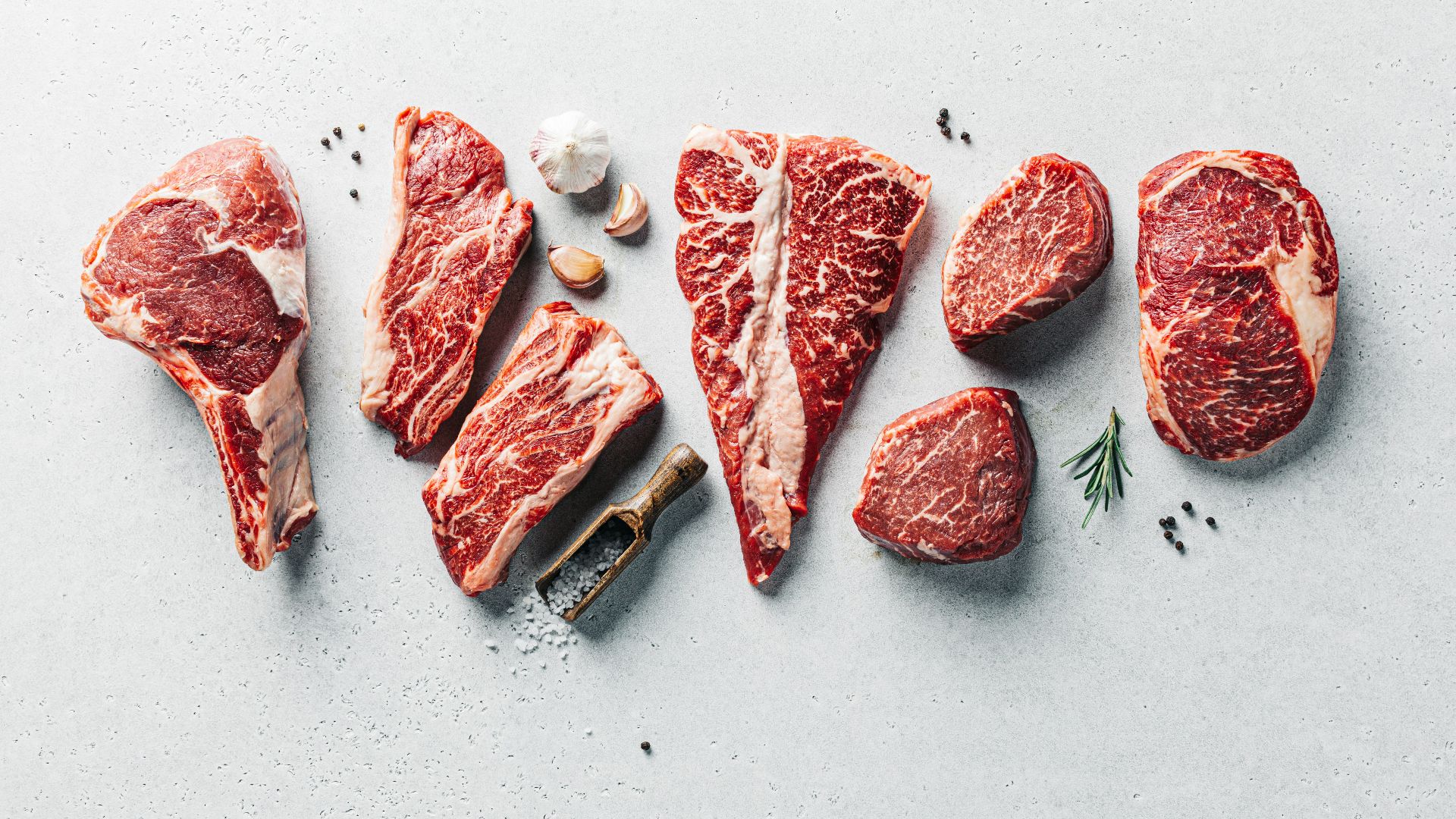 a group of raw meats on a table