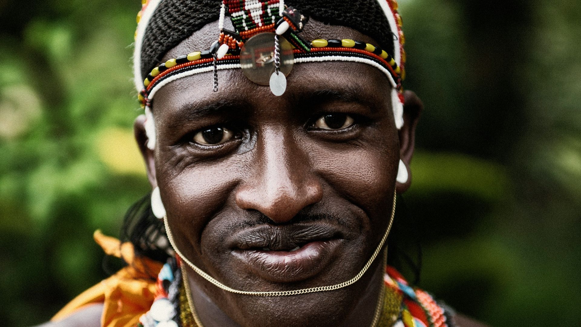 selective focus photography smiling man wearing multicolored costume