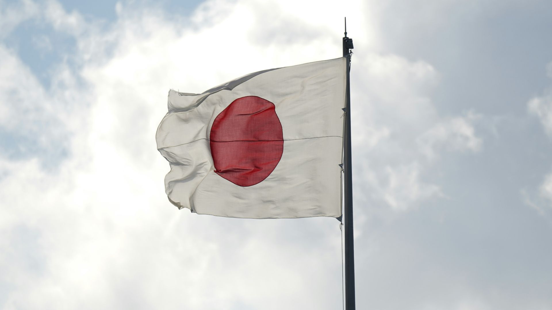 a white and red flag flying in the sky