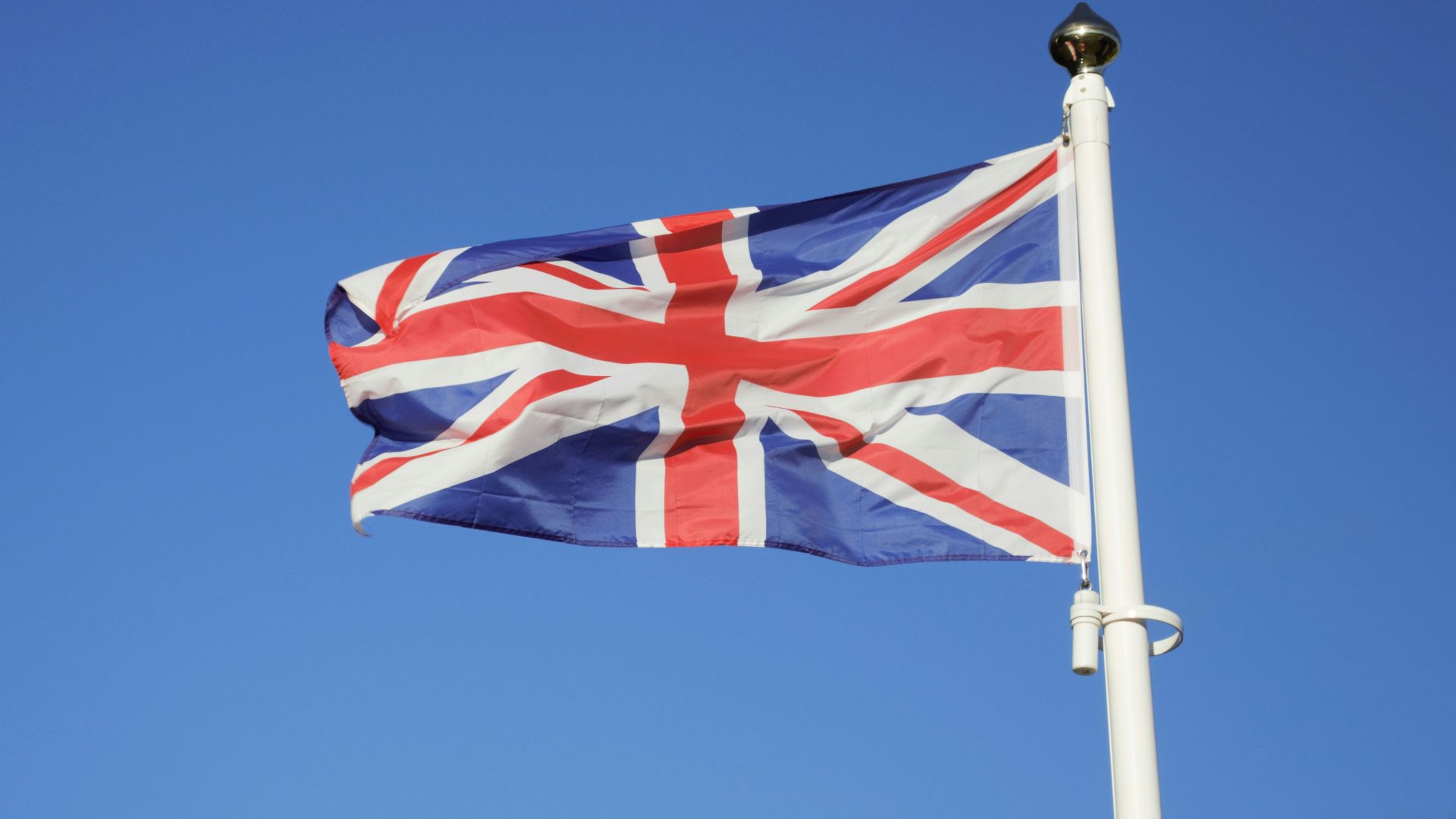 us a flag on pole under blue sky during daytime