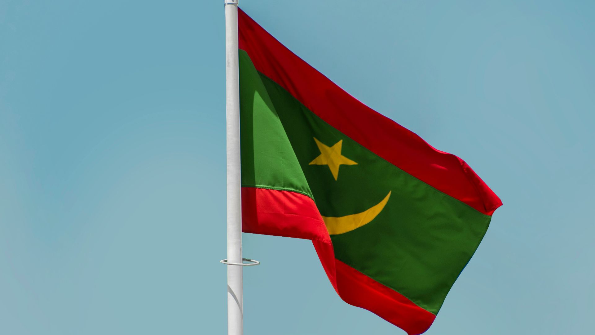 a red and blue flag on a flagpole