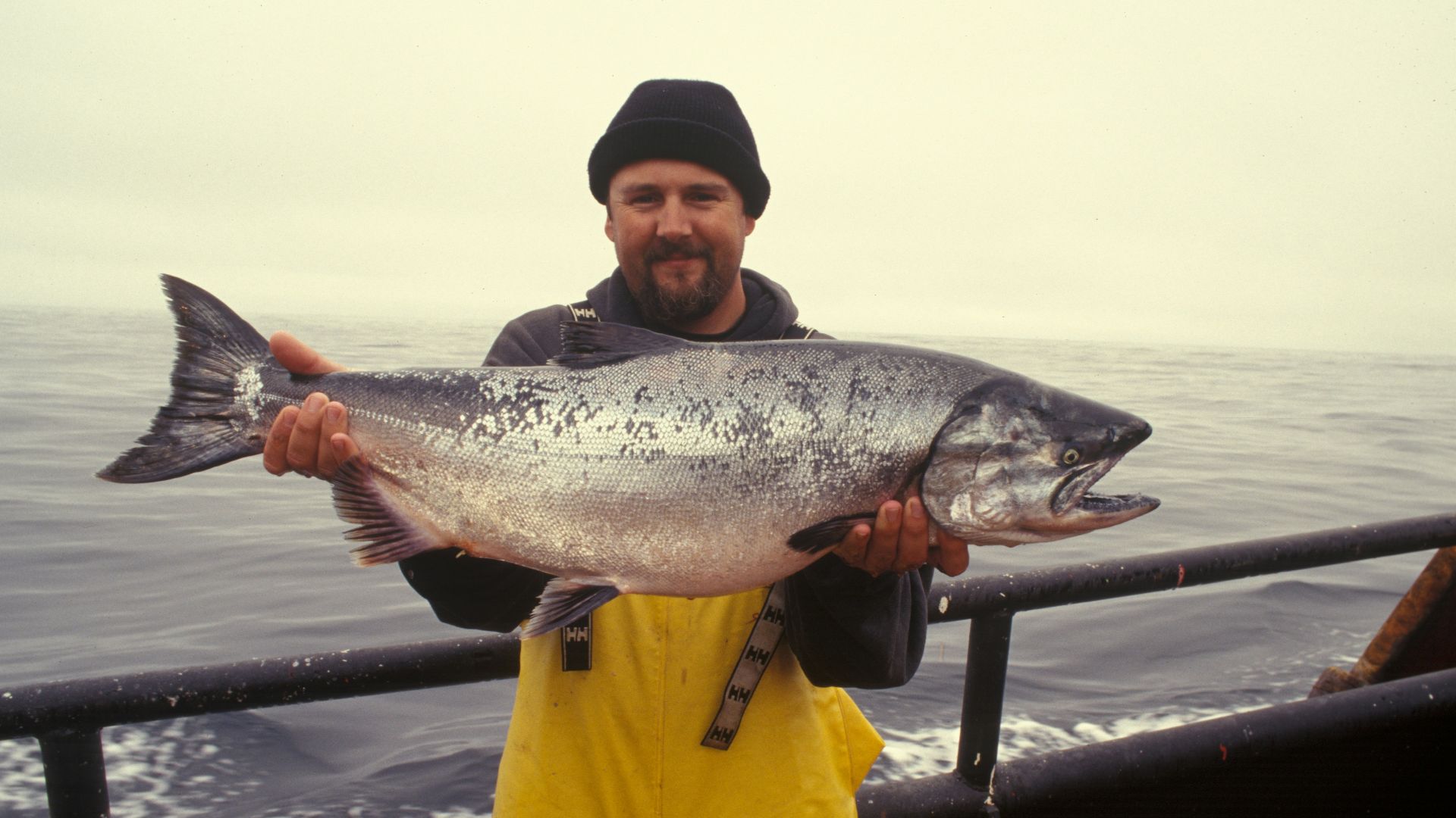 man carrying silver fish